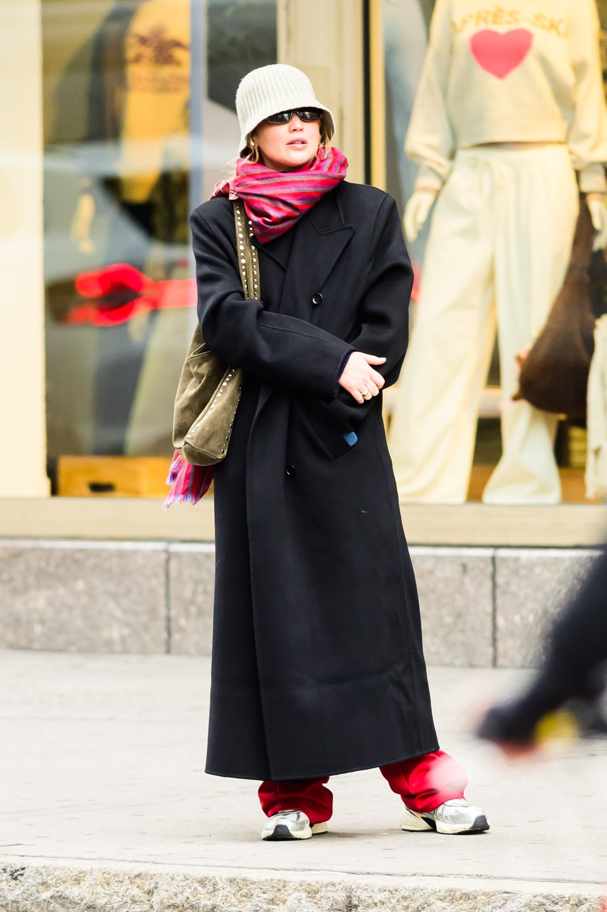 Jennifer Lawrence wears a colorful scarf with a black coat.
