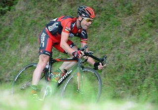 Cadel Evans (BMC) chases back on after several punctures