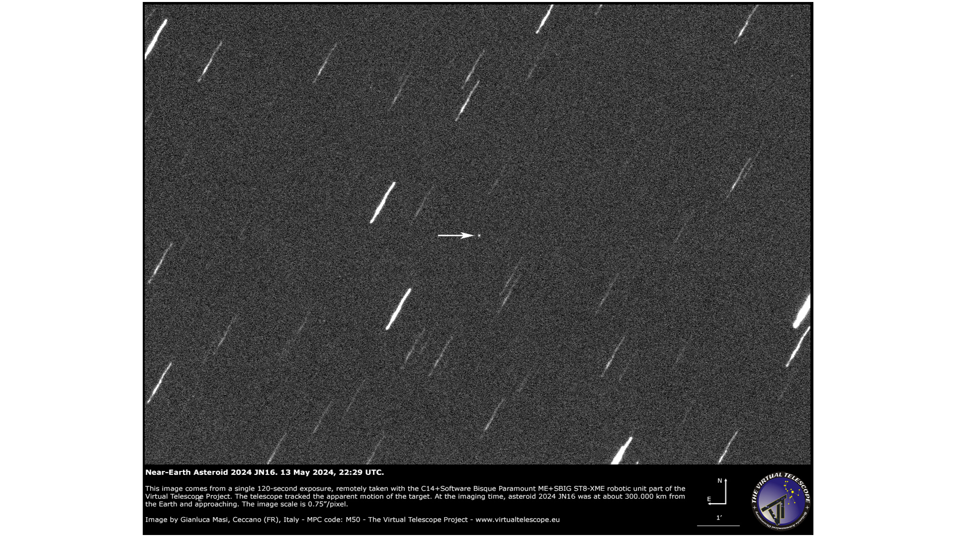 telescope photo of the sky, showing white streaks that represent stars and a small white dot that's an asteroid