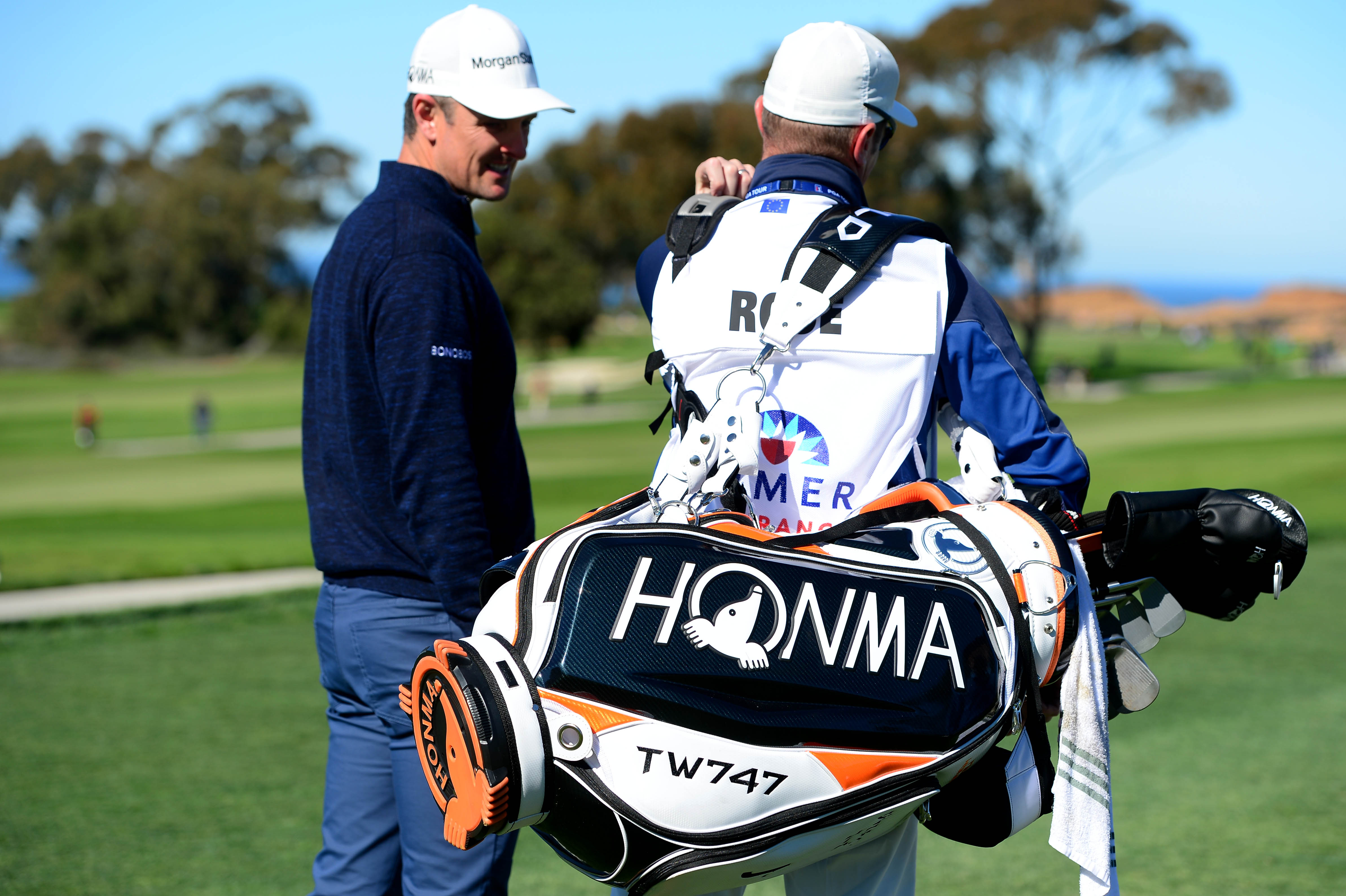 Justin Rose talks to his caddie on his bag during the Pro-Am for the 2019 Farmers Insurance Open at the Torrey Pines Golf Course