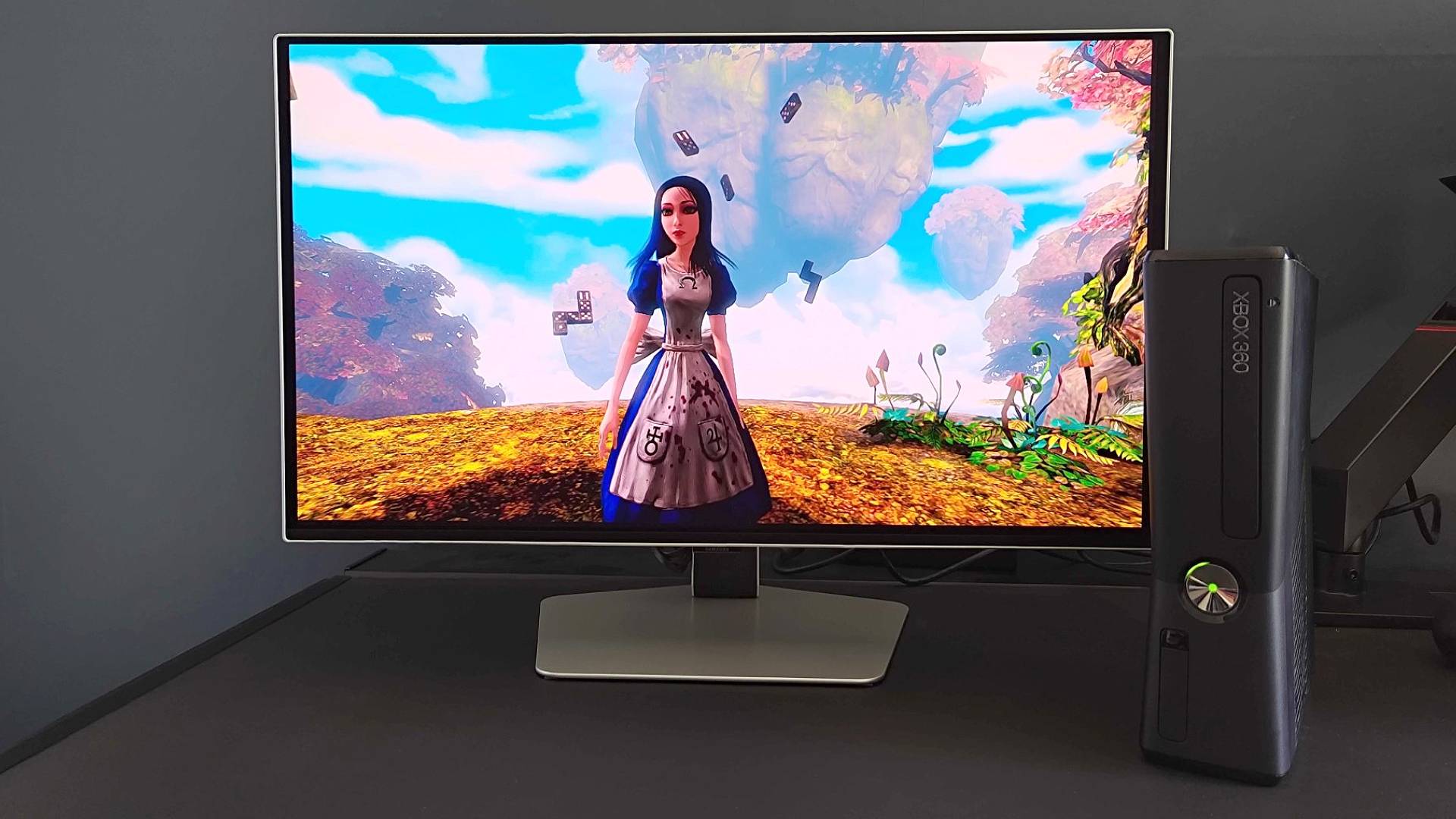 Xbox 360 connected to Samsung Odyssey G6 using mClassic HDMI upscaler running Alice: Madness Returns with main character facing camera.
