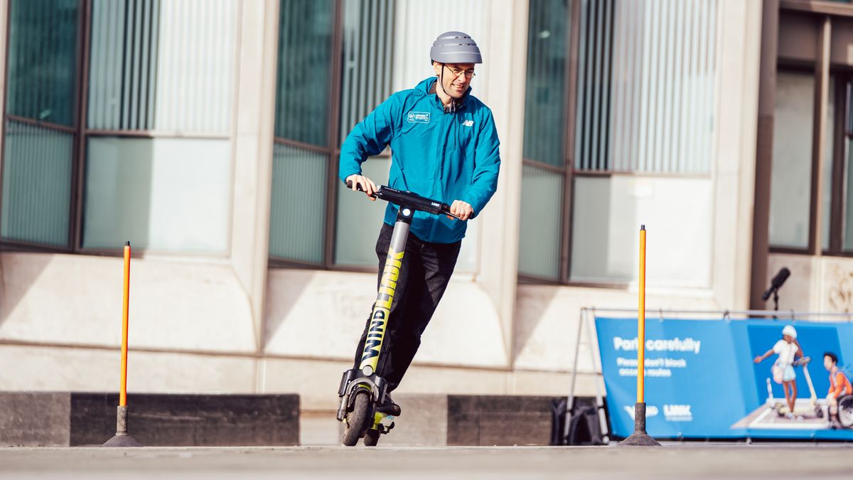 Man riding an e-scooter on a training course