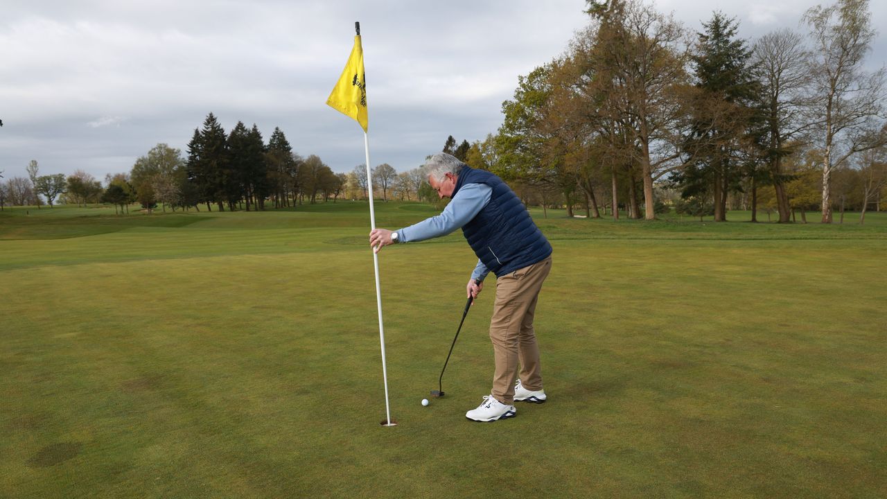 Can you hold the flagstick as you tap in?