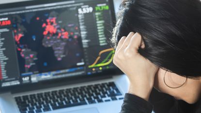 A woman reading news/updates about coronavirus and getting anxiety/depression.