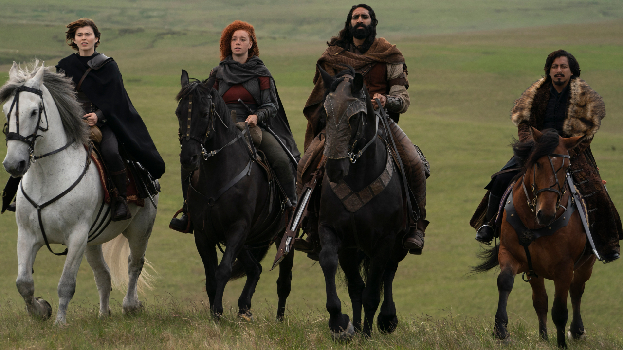 Ruby Cruz, Erin Kellyman, Amar Chadha-Patel, and Tony Revolori riding through an open field on horseback in Willow.