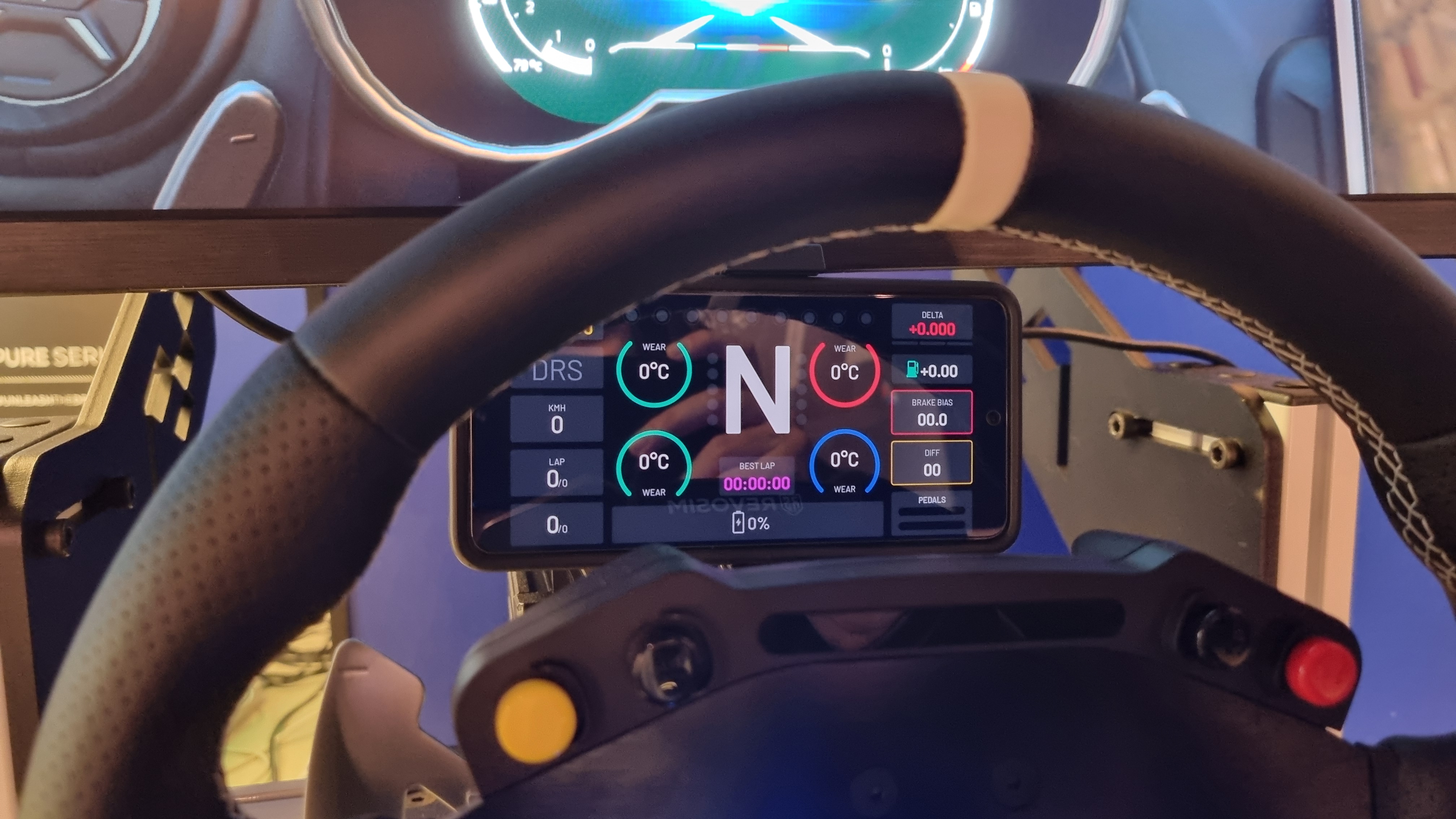 A phone being used as a virtual dashboard on a Revosim RS Pure racing setup.