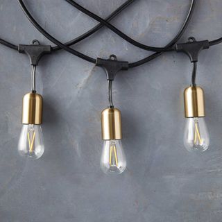 three festoon lights with brass fittings on black cable