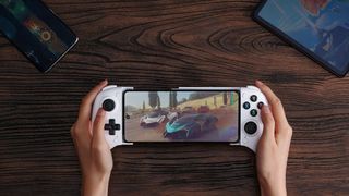 8BitDo Ultimate Mobile gaming Controller in white held over a table