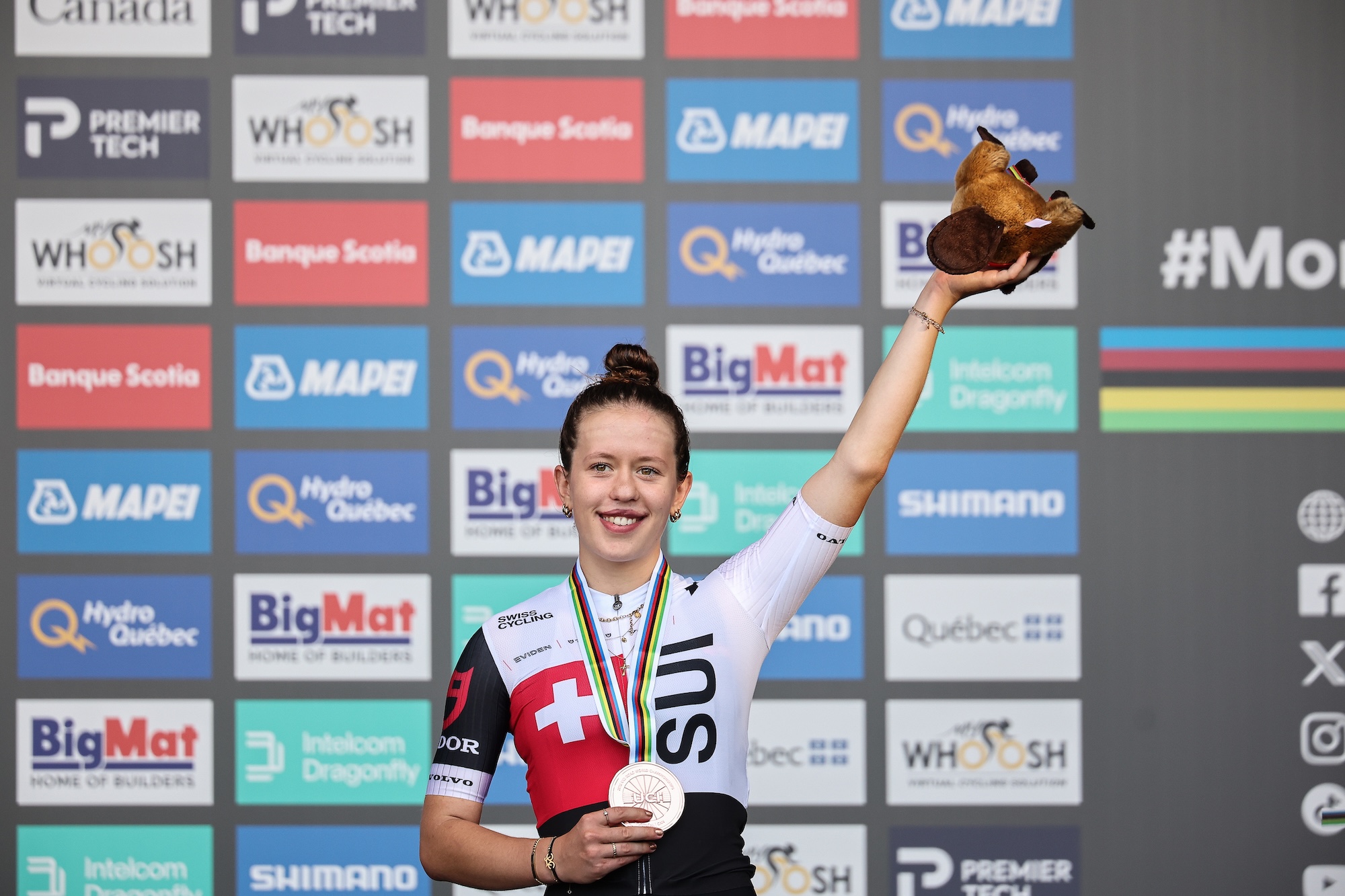 Anja Grossmann (Switzerland) hoists her prize and clutches bronze medal from the women junior road race at 2026 UCI Road World Championships