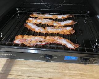 Four rashers of streaky bacon cooked using the KitchenAid Digital Countertop Oven with Air Fryer
