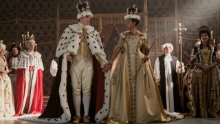 (L to R) Corey Mylchreest as Young King George and India Amarteifio as Young Queen Charlotte holding hands and Michelle Fairley as Princess Augusta at the coronation.