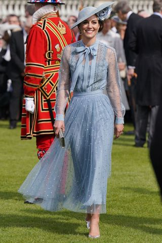 The Princess of Wales wears a pale blue blouse and skirt with matching fascinator at the King's Coronation Garden Party