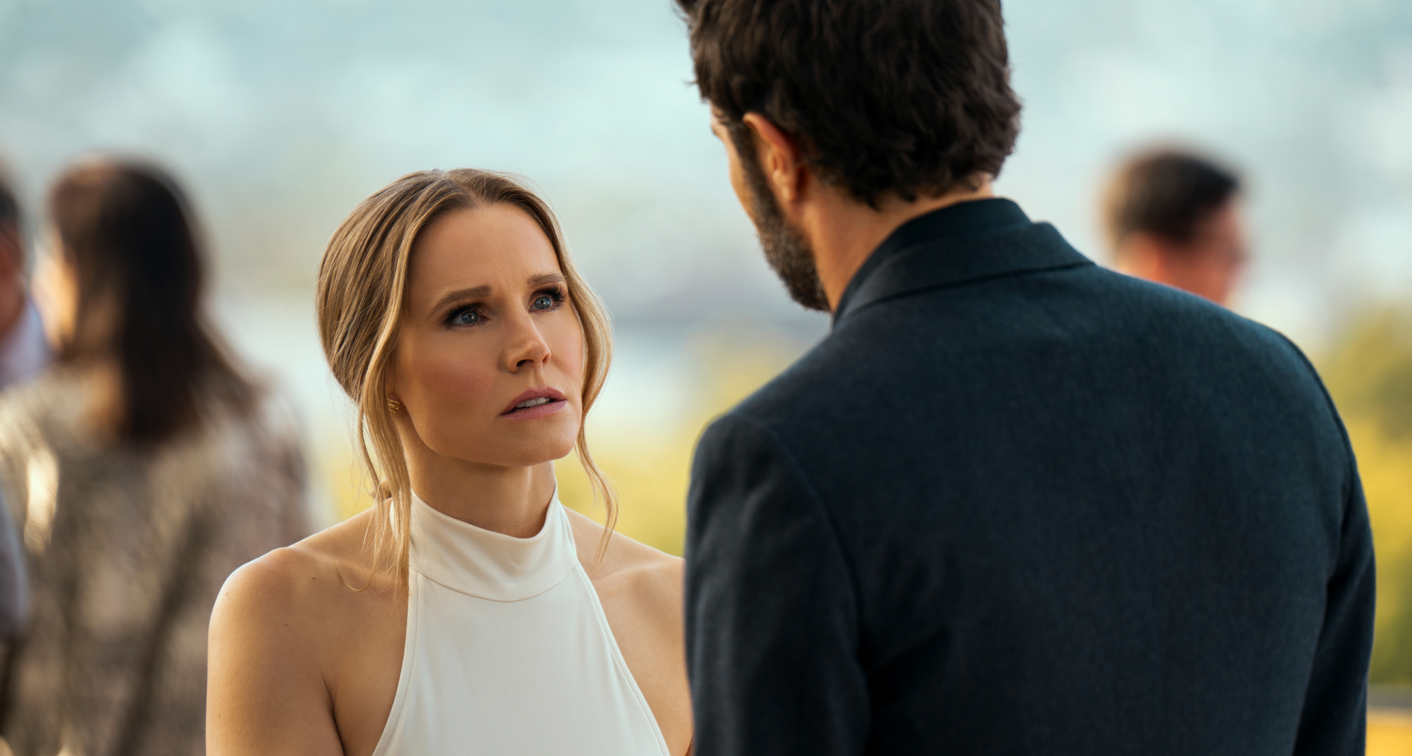 kristen bell in a white dress and adam brody in a suit having a dramatic conversation in the nobody wants this season 2 finale