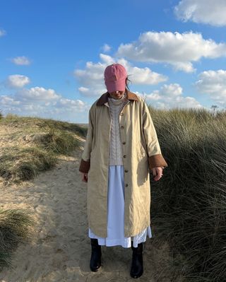 @claudia_berresford wearing a jacket, jumper, dress and boots