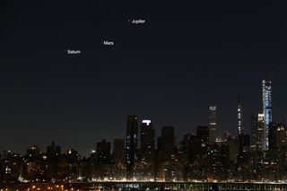 Saturn, Mars and Jupiter align over the New York City skyline on March 26, 2020.
