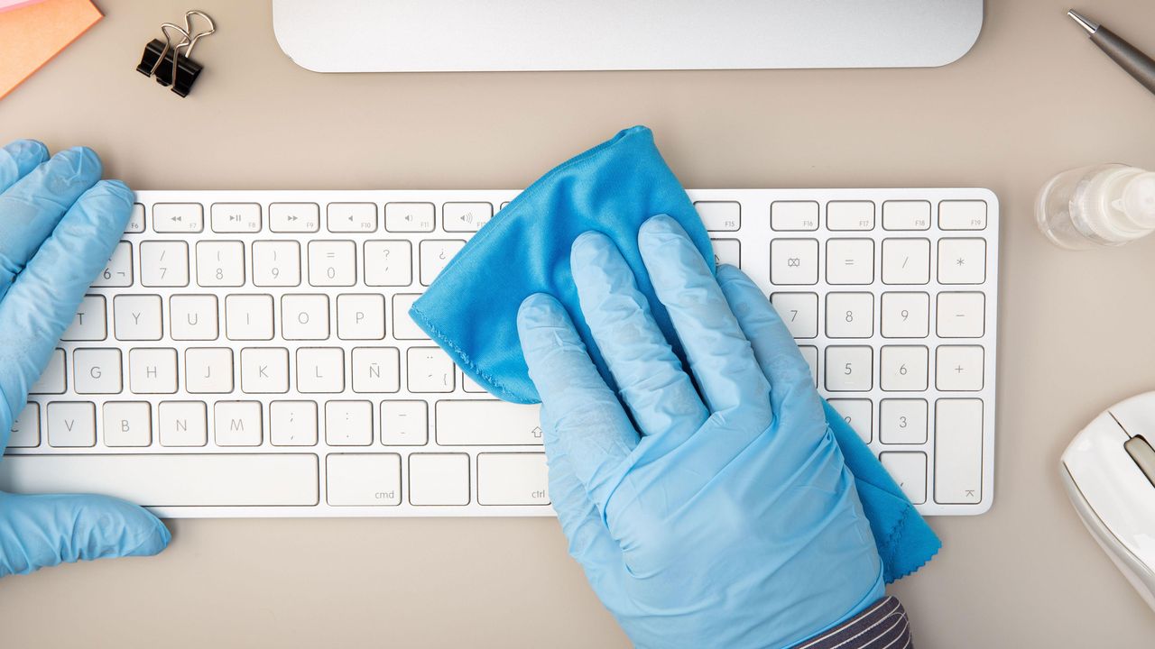 cleaning a computer keyboard with a cloth