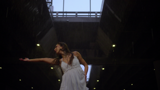 a woman (Melanie Wilking) dances in a large room with a skylight, in a still from 'Dancing for the Devil: The 7M TikTok Cult'