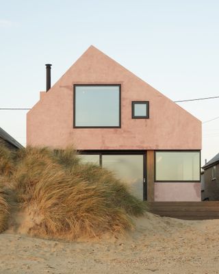 A close-up of the pink home on the beach