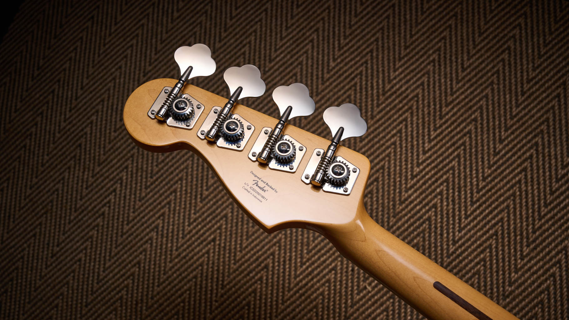 Squier Classic Vibe 70s Jazz Bass Active: finished in Ocean Turquoise, this keenly priced four-string is photographed in close-up with a patterned rug and wooden floor in the background.