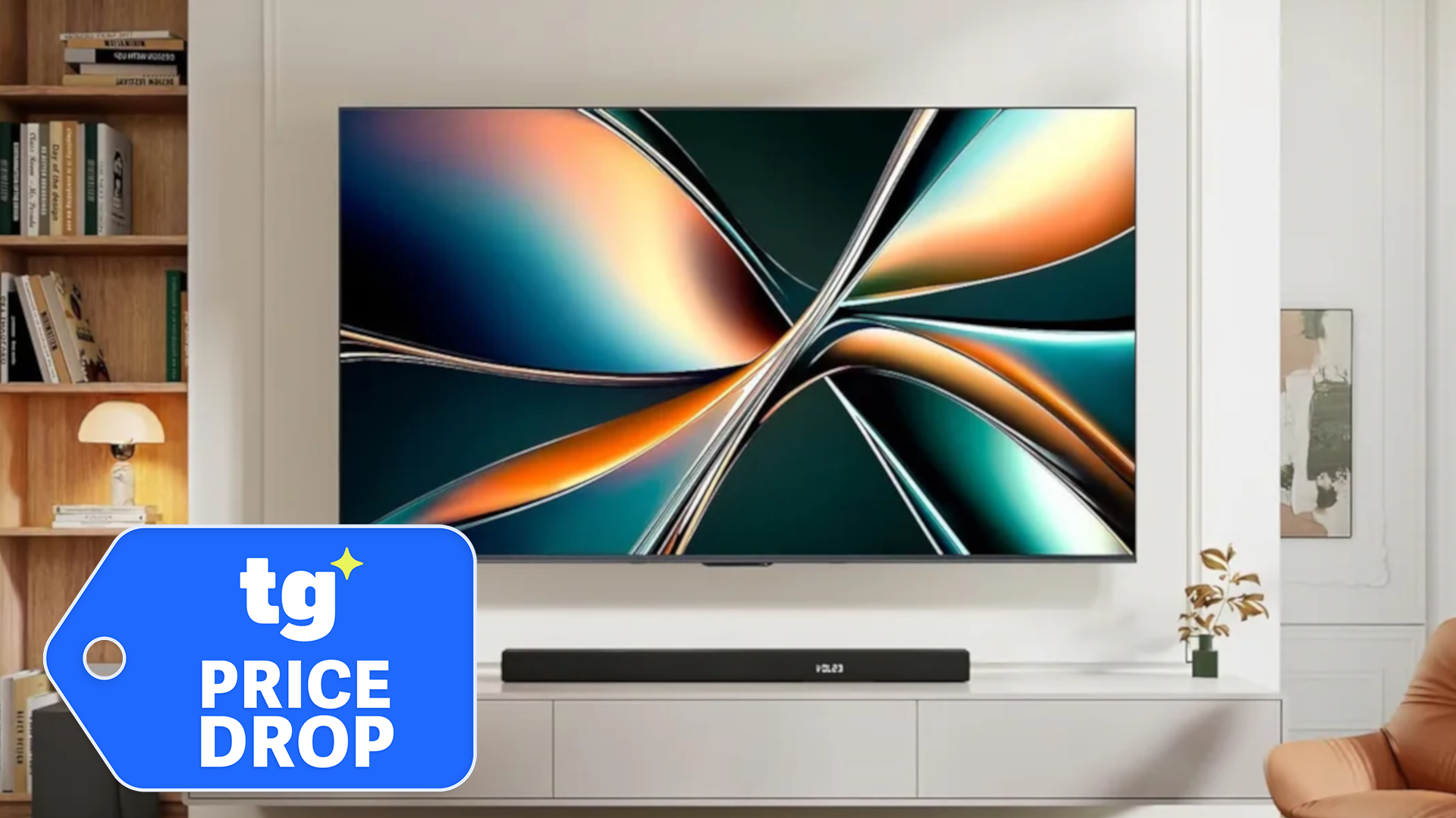 The Hisense U65QF, wall-mounted in a modern living space next to a superimposed, blue-colored tag that reads: "TG Price Drop"
