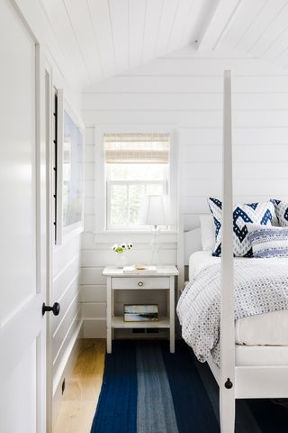 White coastal bedroom with shiplap paneling
