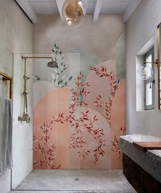 A walk in shower with a huge painted mural on the wall