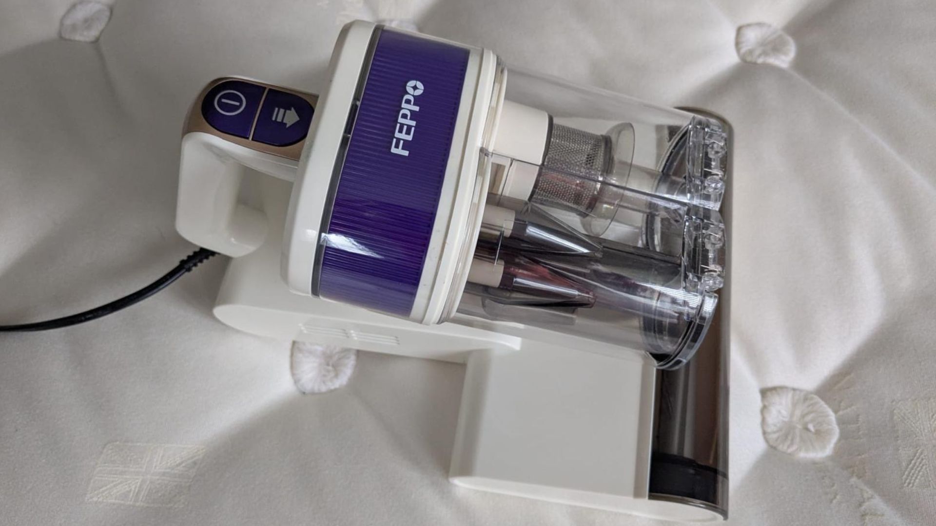 Our tester uses the white FEPPO Mattress Vacuum Cleaner to remove fine dust and particles from inside her mattress and pillow
