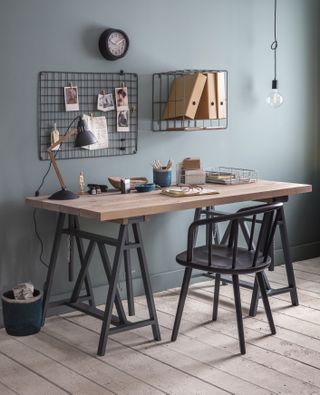 Home office with industrial style metal shelves and wooden desk
