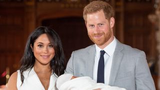 Prince Harry, Duke of Sussex and Meghan, Duchess of Sussex, pose with their newborn son Archie Harrison Mountbatten-Windsor during a photocall in St George's Hall at Windsor Castle on May 8, 2019 in Windsor, England.