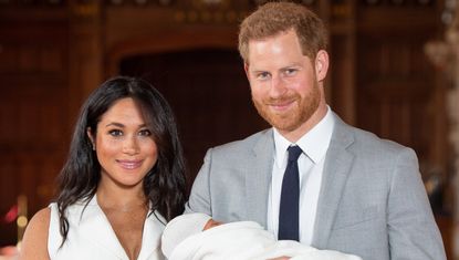 Prince Harry, Duke of Sussex and Meghan, Duchess of Sussex, pose with their newborn son Archie Harrison Mountbatten-Windsor during a photocall in St George's Hall at Windsor Castle on May 8, 2019 in Windsor, England. 
