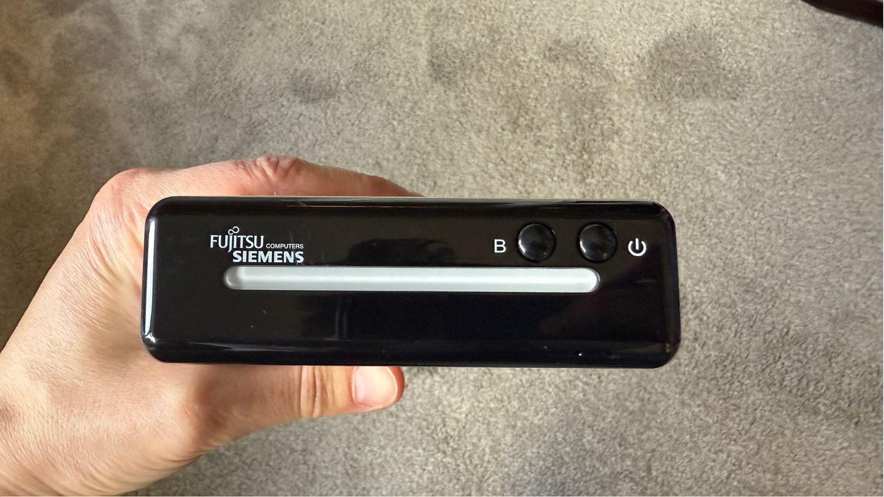 An old external hard drive in hand.