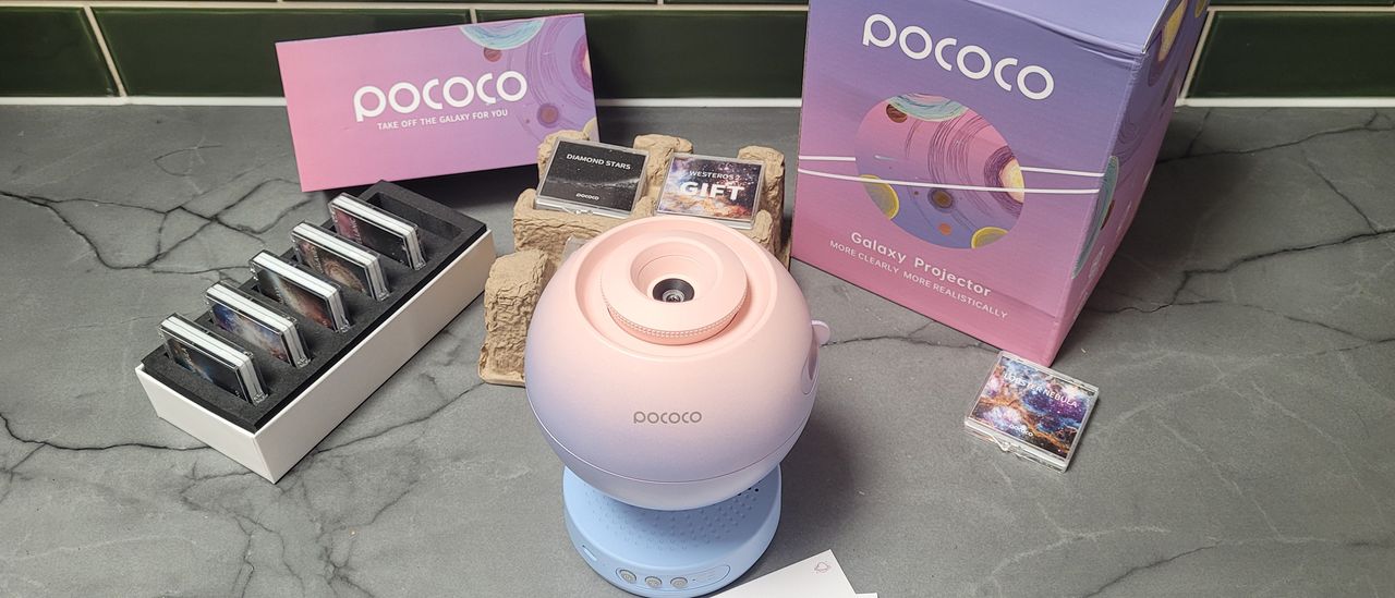 The Pococo projector on a worksurface alongside extra disks and their packaging