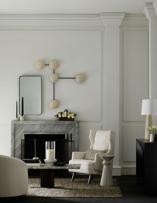 living room with fire surround, statement wall light and mirror