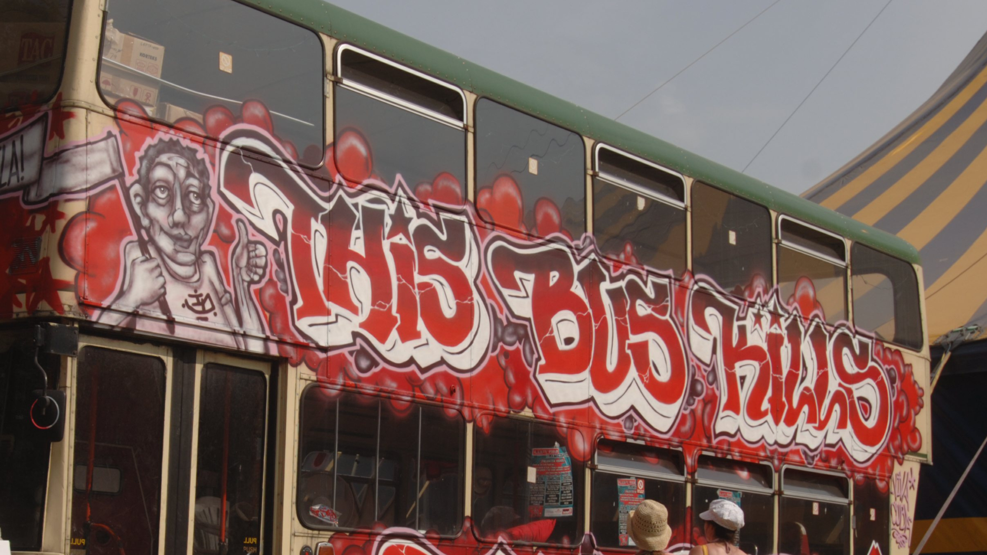 A bus with 'This Bus Kills' written on the side at Glastonbury Festival