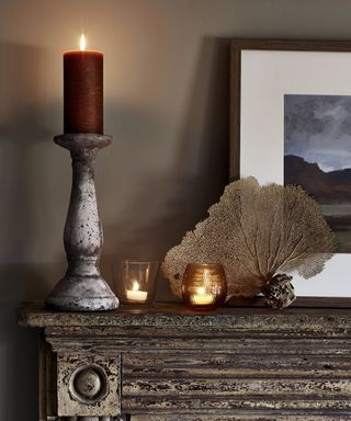 Autumnal candles on a mantle piece