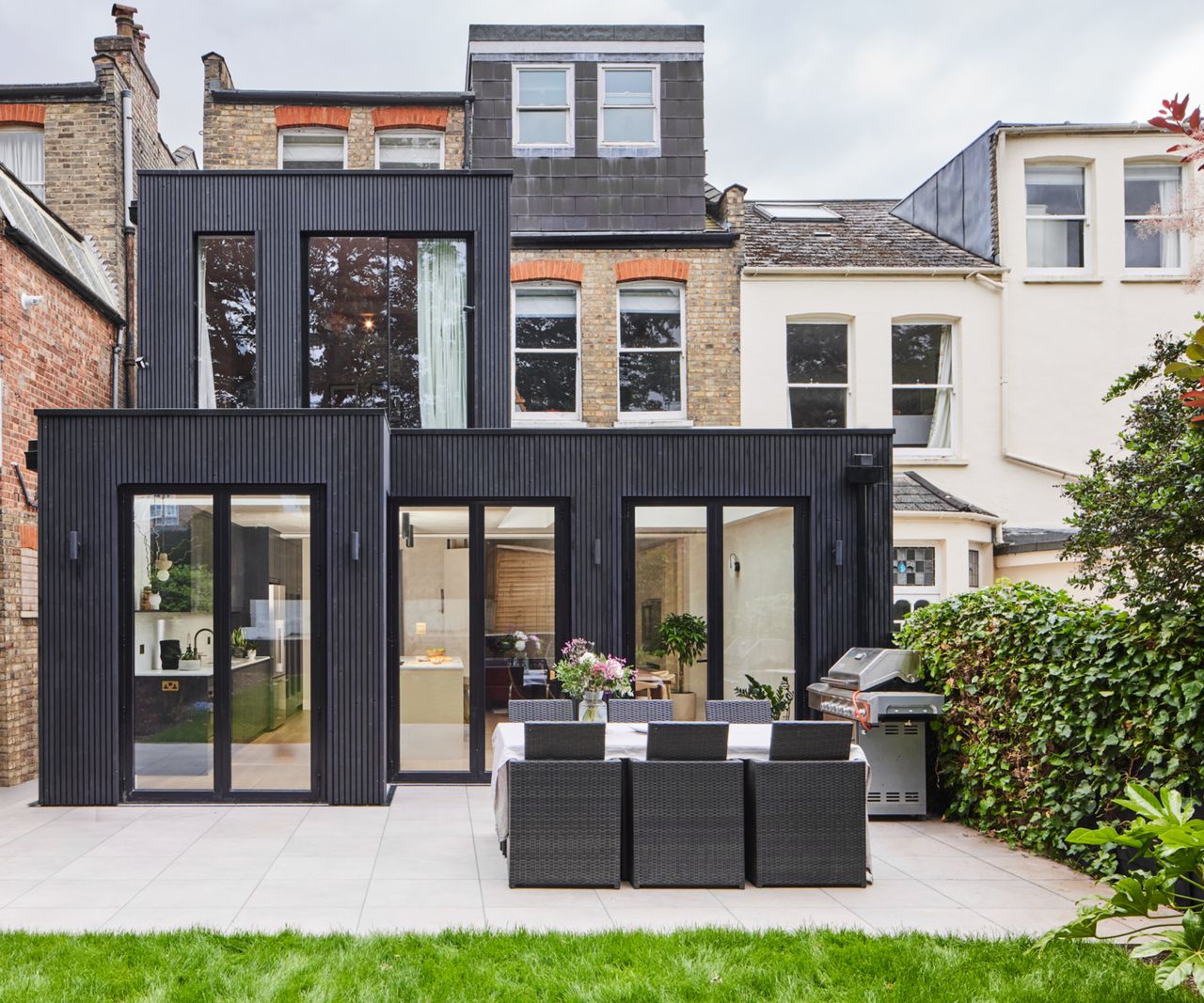rear exterior shot of black clad extensions to terraced house