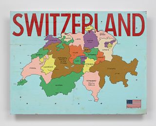 View of Switzerland, 2018, by Tom Sachs - a colourful map of African countries with a blue background, the American flag in the corner and the wording 'SWITZERLAND' in red