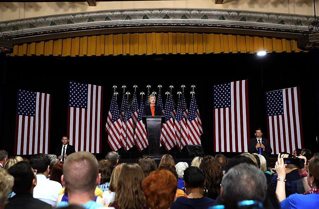 How many flags did Hillary have behind her?