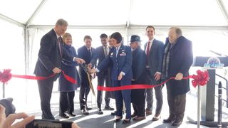 Rocket Lab CEO Peter Beck (third from left in back) uses giant novelty scissors in a ribbon-cutting ceremony to open Launch Complex 2 at the Mid Atlantic Regional Spaceport at NASA's Wallops Flight Facility in Virginia on Dec. 12, 2019.