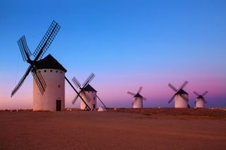 A group of windmills captured at dusk