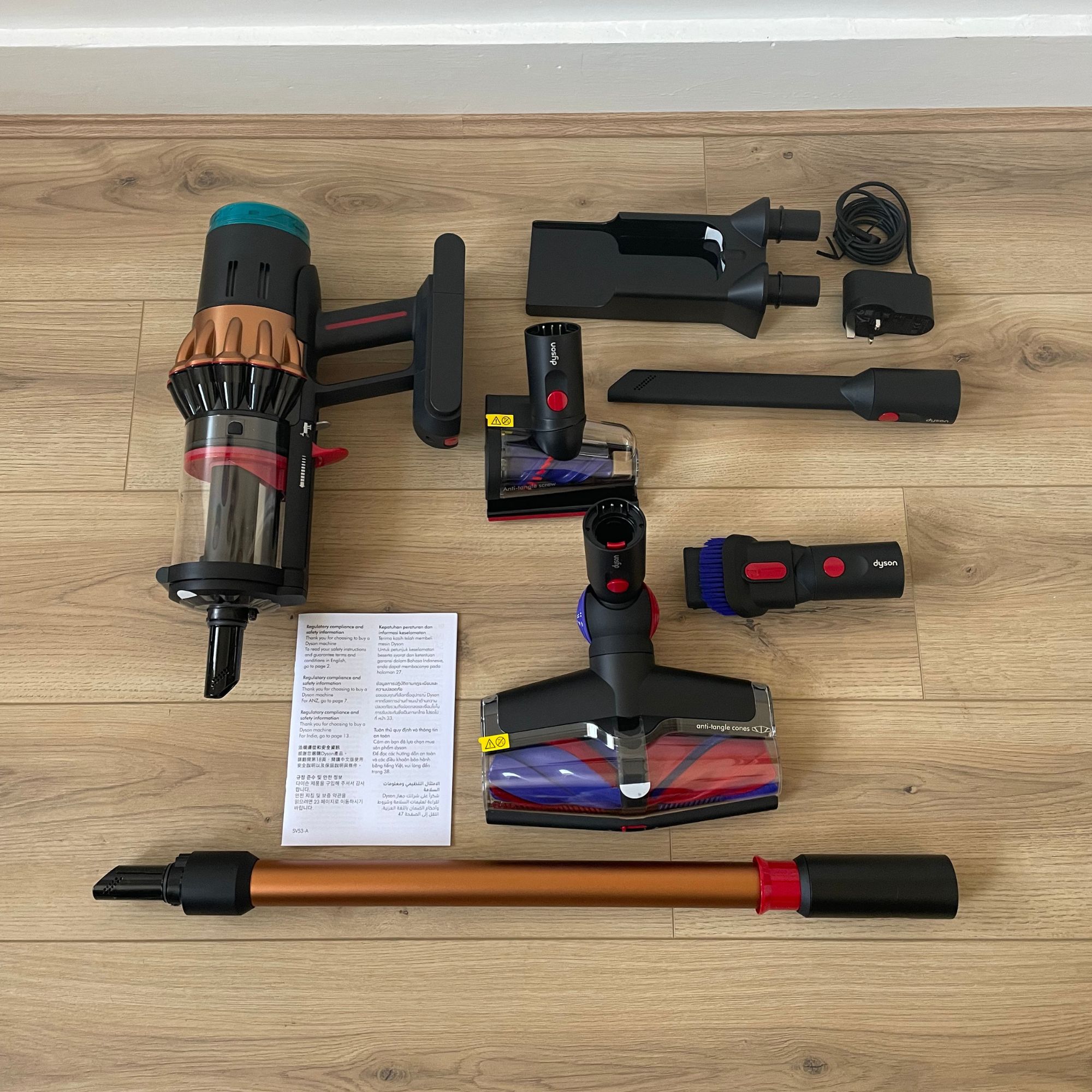Dyson V16 Piston Animal components laid out on wood-effect flooring