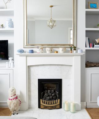 Painted fireplace in a renovated living room with a mirror above it