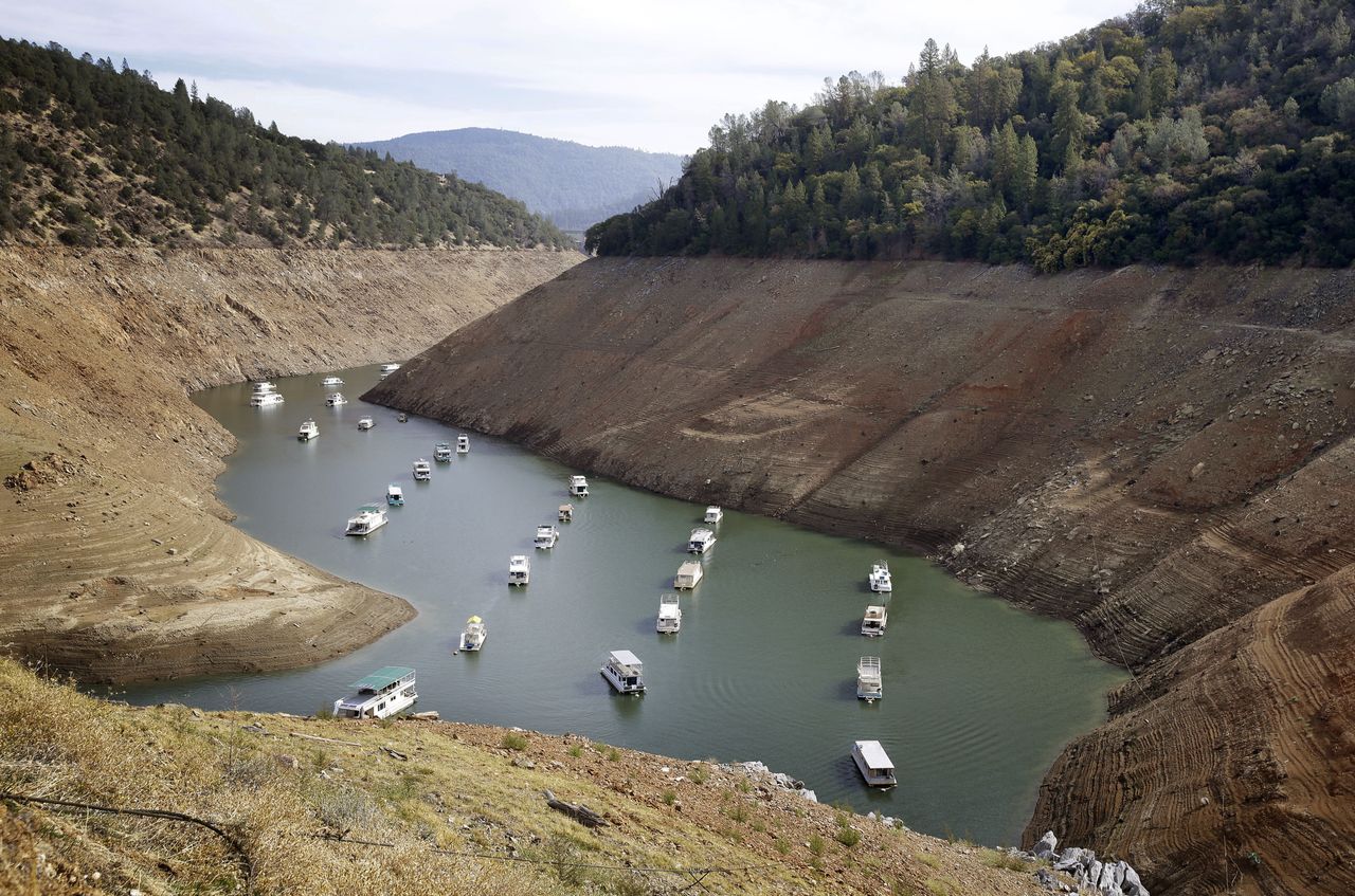 Houseboats float in a drought-lowered lake.