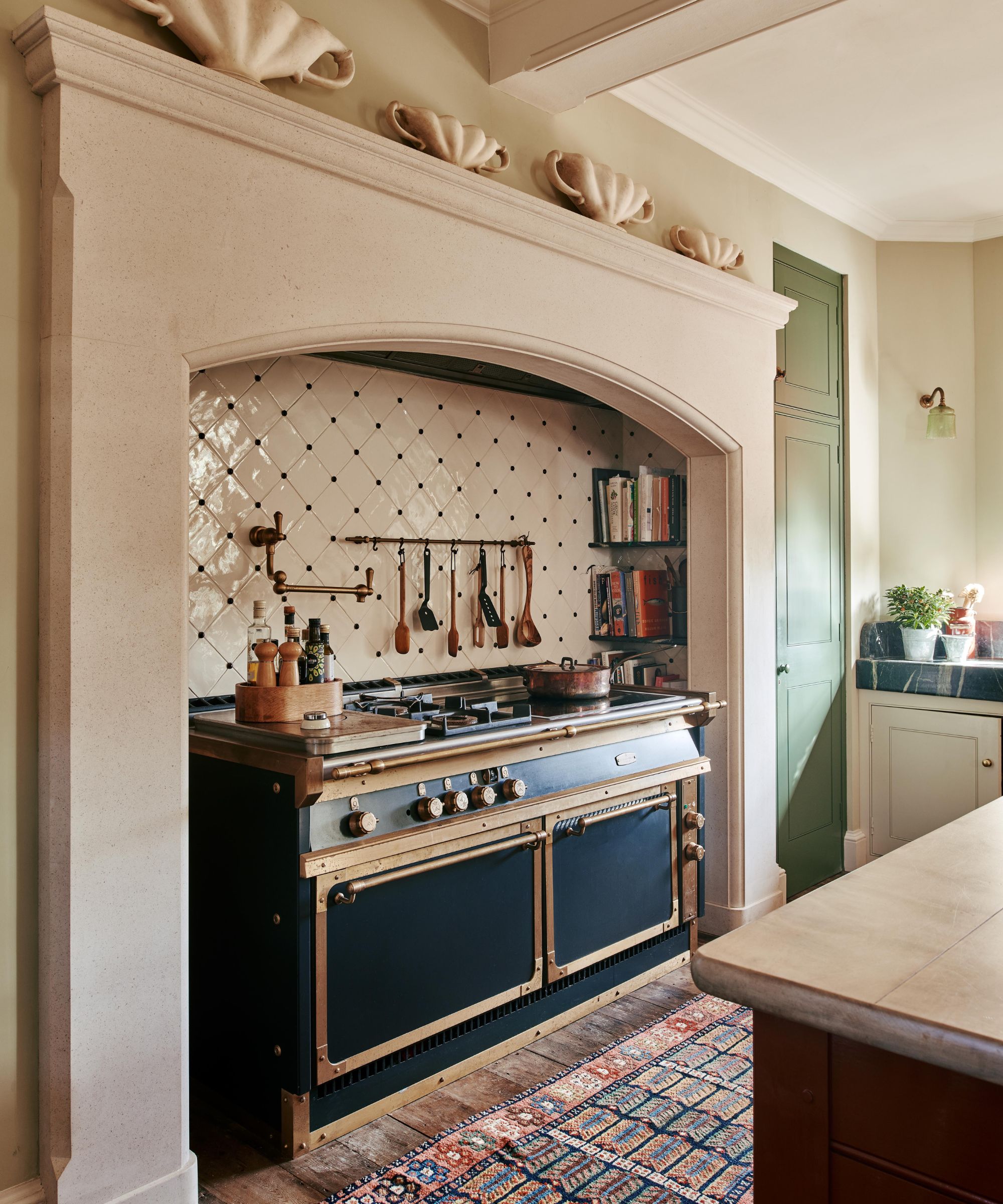 A traditional kitchen with an original hearth used as the range area