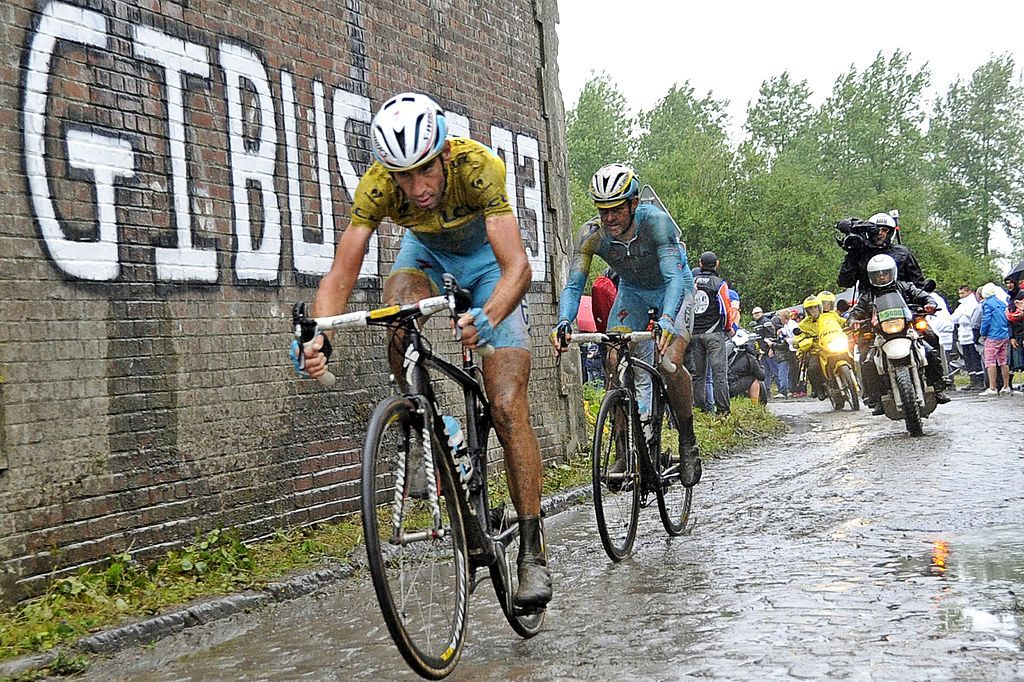Italys Vincenzo Nibali L wearing the overall leaders yellow jersey rides during the 1525 km fifth stage of the 101st edition of the Tour de France cycling race on July 9 2014 between Ypres northwestern Belgium and Arenberg Porte du Hainaut in Wallers northern France AFP PHOTO FRANCOIS LO PRESTI Photo credit should read FRANCOIS LO PRESTIAFP via Getty Images