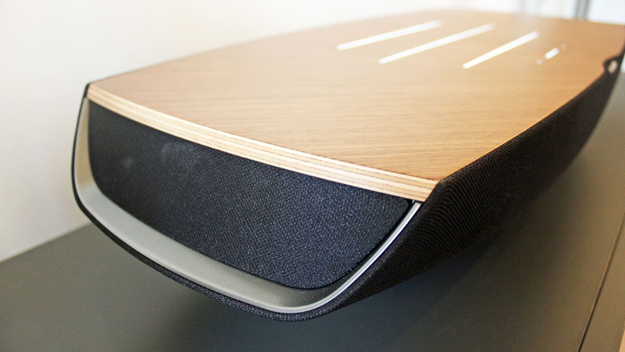 A close view of the end of the Sonus Faber Omnia speaker, showing a recessed area with. afabric cover for some of the speaker drivers.
