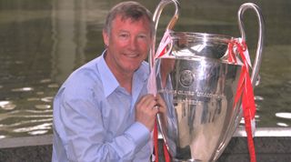 Manchester United manager Sir Alex Ferguson poses with the Champions League trophy, 1999.