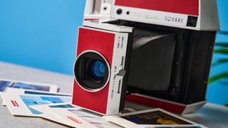 A red and gray Lomography Lomo'Instant Square Glass instant camera