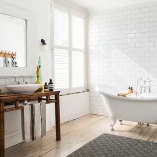 Bathroom with wooden flooring and bath tub