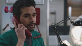 EMBARGO 9/9/25 Rash Masum answers Holby ED's emergency red phone and hears Sunny has been seriously injured.